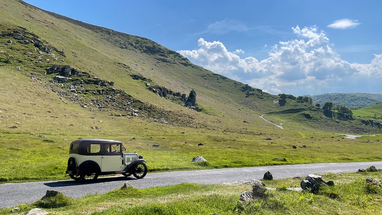 A classic car driving along the road that leads from Lynton to the Valley of the Rocks